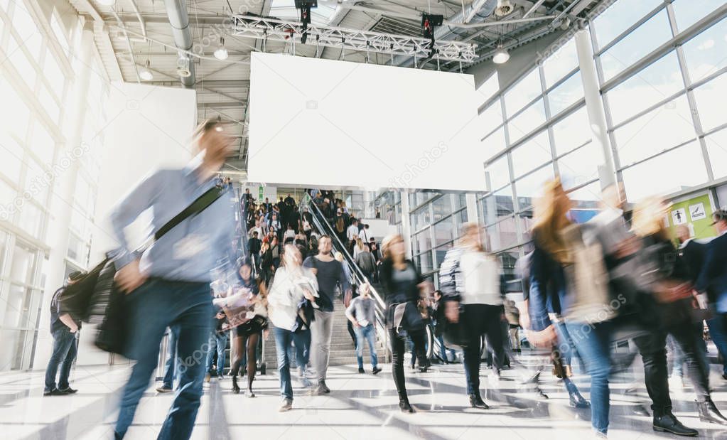 crowd of anonymous blurred business people at a tradeshow