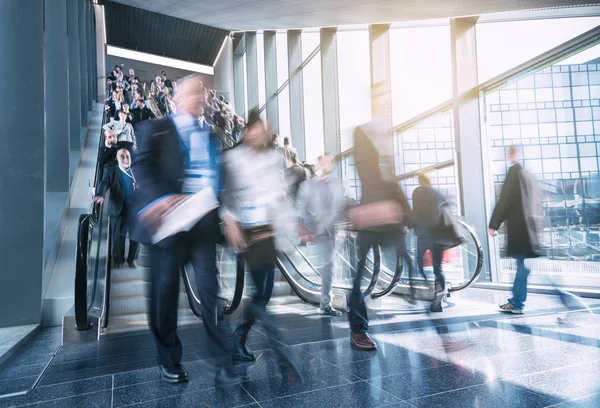 blurred business people at a trade show staircases