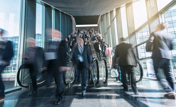 blurred people business at a trade fair staircases