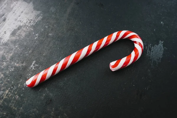 Candy canes in Christmas colours on a dark surface — Stock Photo, Image
