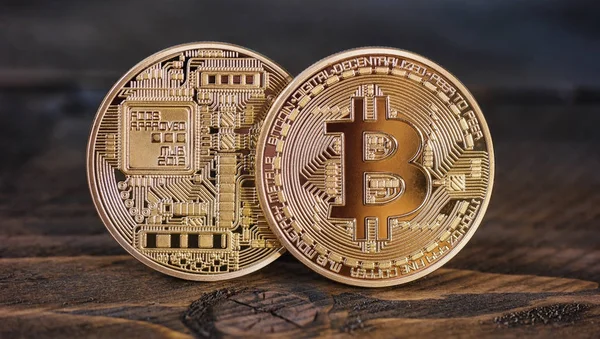 Golden Bitcoins on a wooden table — Stock Photo, Image