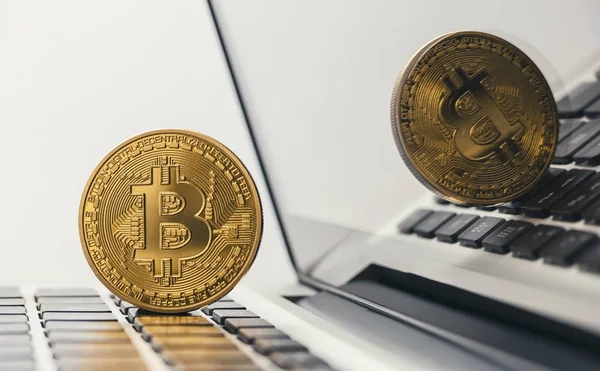 Golden bitcoin on notebook — Stock Photo, Image