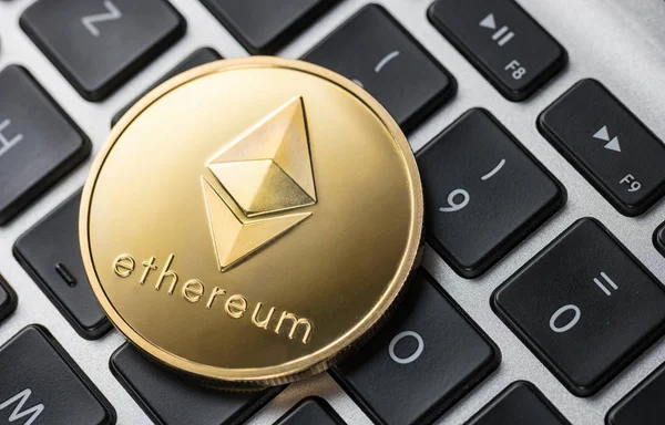 Golden ethereum coin on notebook — Stock Photo, Image