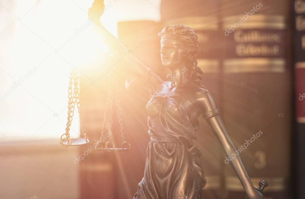 Lady Justice (Justitia) with law books