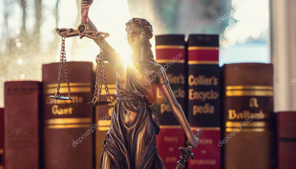 Lady Justice (Justitia) with law books  in a lawyer office