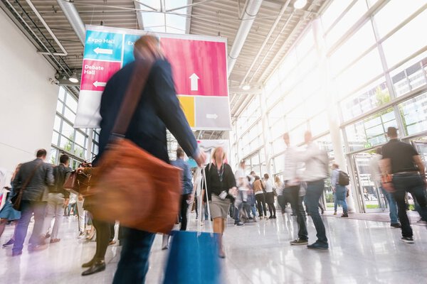unrecognizable business people walking at a trade fair
