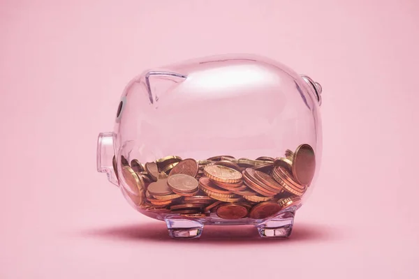 Transparent piggy bank with money coins — Stock Photo, Image