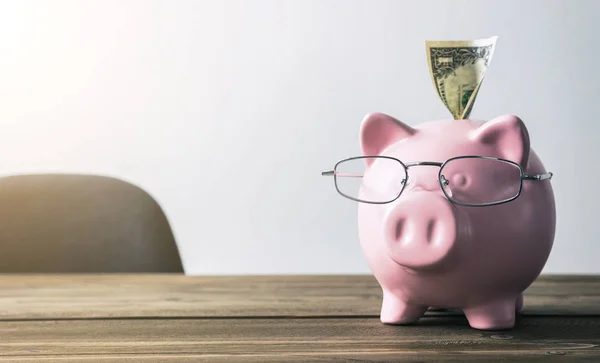 Piggy bank with dollar note — Stock Photo, Image