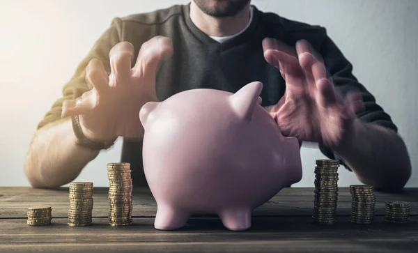 Hipster hand taking care of piggy bank — Stock Photo, Image
