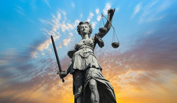 Justitia lady with cloudy sunset sky