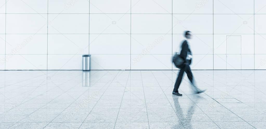 Blurred business people walking alone on a floor