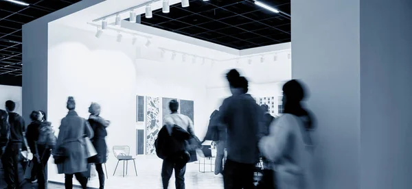 business people crowd at an trade show booth