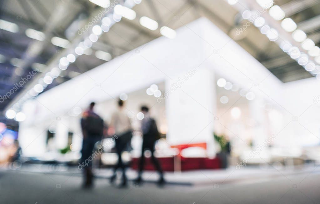 people walking in trade fair booth Intentionally blurred backgro