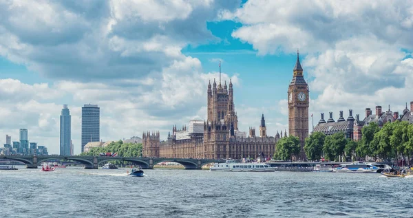 view from the thames river to the Houses of Parliament and Big Ben with dramatic clouds in london. ideal for websites and magazines layouts