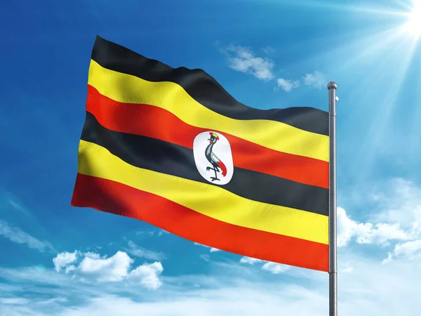 Bandeira ugandense acenando no céu azul — Fotografia de Stock