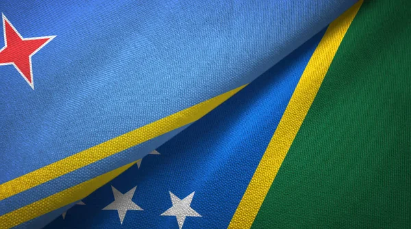 Αρούμπα και Νήσοι Σολομώντος δύο σημαίες ύφασμα, υφασμάτινη υφή — Φωτογραφία Αρχείου