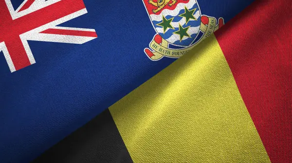 Kaaimaneilanden en België twee vlaggen textieldoek, textieltextuur — Stockfoto