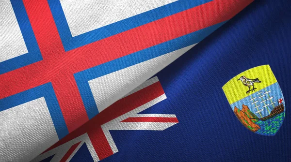 Faeröer en Saint Helena twee vlaggen textiel doek, stof textuur — Stockfoto