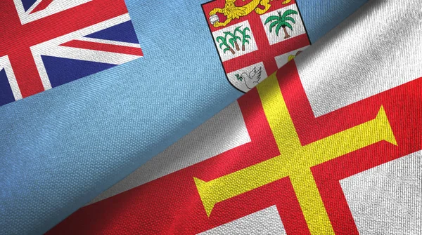 Fiji y Guernsey dos banderas tela textil, textura de la tela — Foto de Stock