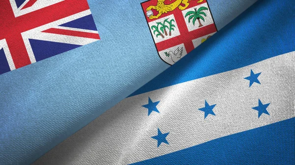 Fiji y Honduras dos banderas de tela textil, textura de tela —  Fotos de Stock