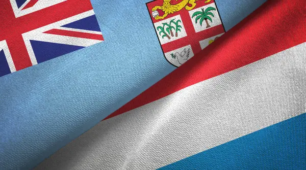 Fiji y Luxemburgo dos banderas tela textil, textura de la tela —  Fotos de Stock
