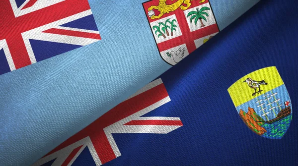 Fiji y Santa Helena dos banderas tela textil, textura de la tela — Foto de Stock