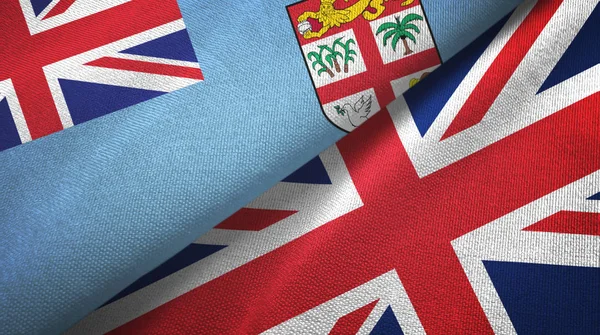 Fiji y Reino Unido dos banderas tela textil, textura de la tela —  Fotos de Stock
