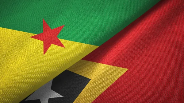 Frans-Guyana en Timor-Leste Oost-Timor twee vlaggen textiel doek, weefsel textuur — Stockfoto