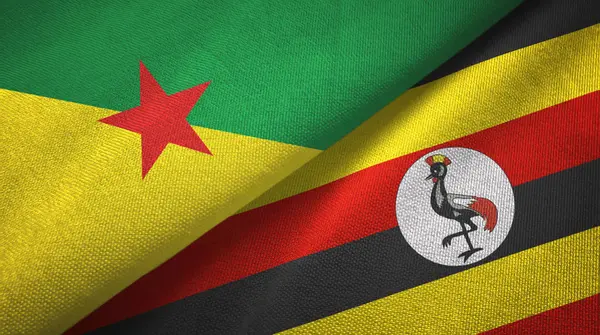 Guiana francese e Uganda due bandiere tessuto, tessitura tessuto — Foto Stock
