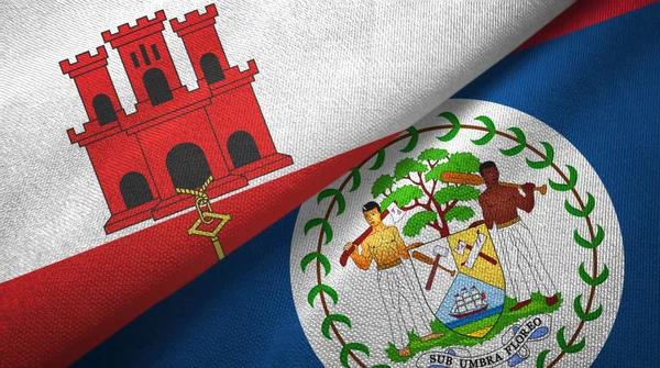 Gibraltar en Belize twee vlaggen textiel doek, stof textuur — Stockfoto