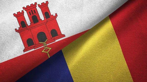 Gibraltar en Roemenië twee vlaggen textiel doek, weefsel textuur — Stockfoto