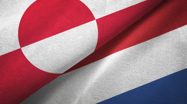 Grenlandia i Holandia dwie flagi tkaniny tekstylne, tekstura tkaniny — Zdjęcie stockowe