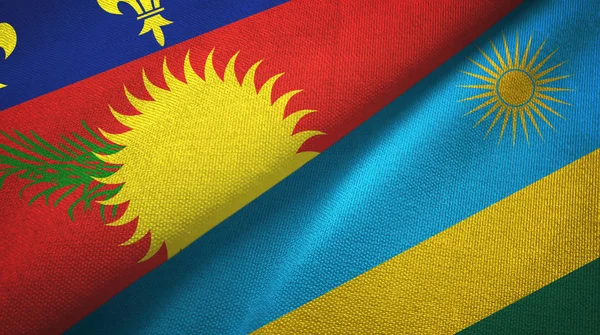Guadeloupe och Rwanda två flaggor textil duk, textur — Stockfoto