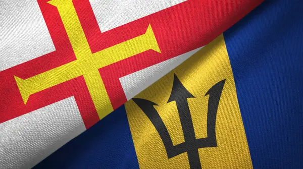 Guernsey y Barbados dos banderas tela textil, textura de la tela — Foto de Stock