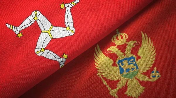 Ilha de Mann e Montenegro duas bandeiras de pano têxtil, textura de tecido — Fotografia de Stock