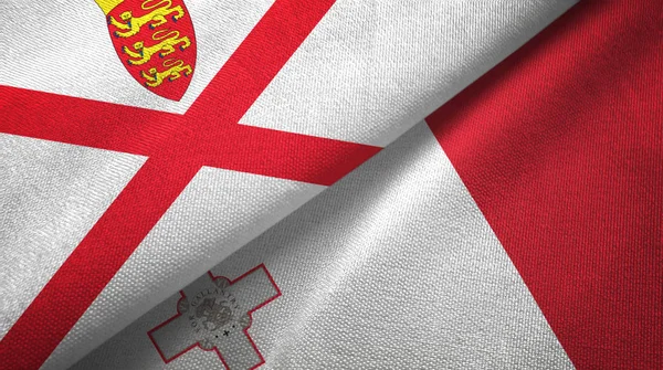 Jersey en Malta twee vlaggen textiel doek, stof textuur — Stockfoto