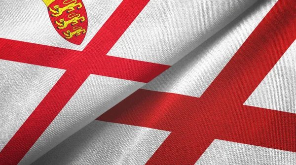 Jersey och Nordirland två flaggor textilduk, tyg struktur — Stockfoto