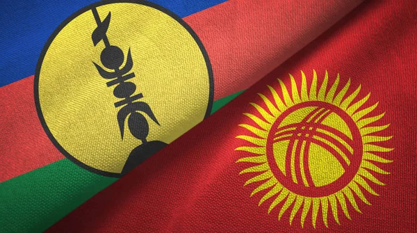 Nuova Caledonia e Kirghizistan due bandiere tessuto, tessitura del tessuto — Foto Stock