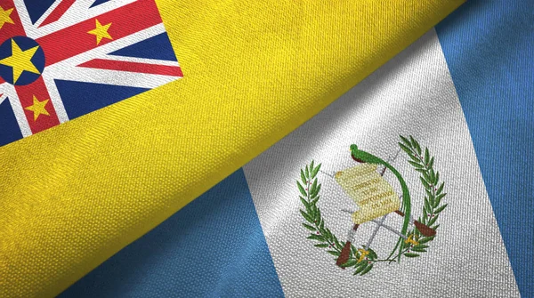 Niue y Guatemala dos banderas de tela textil, textura de tela —  Fotos de Stock