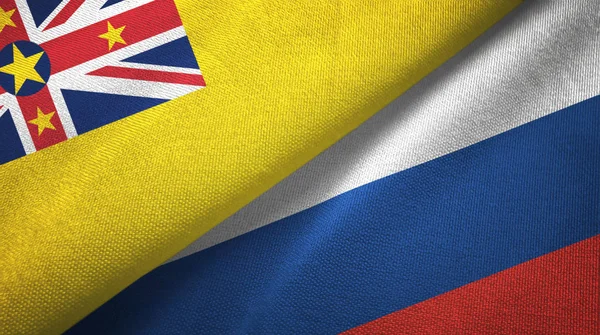 Niue y Rusia dos banderas tela textil, textura de la tela — Foto de Stock