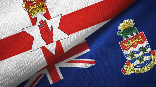 Nordirland och Caymanöarna två flaggor textilduk, textur — Stockfoto