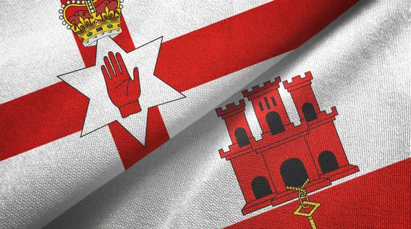 Noord-Ierland en Gibraltar twee vlaggen textieldoek, textieltextuur — Stockfoto