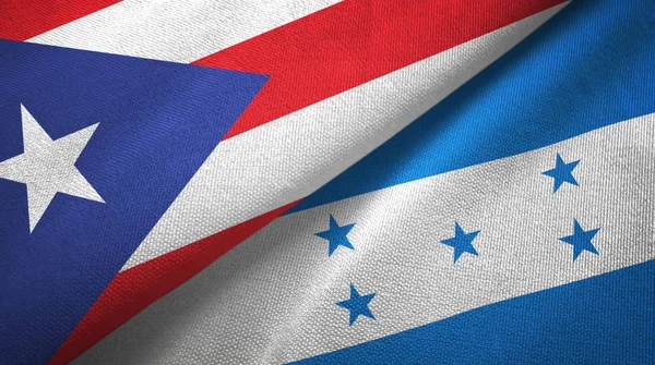 Puerto Rico en Honduras twee vlaggen textiel doek, stof textuur — Stockfoto