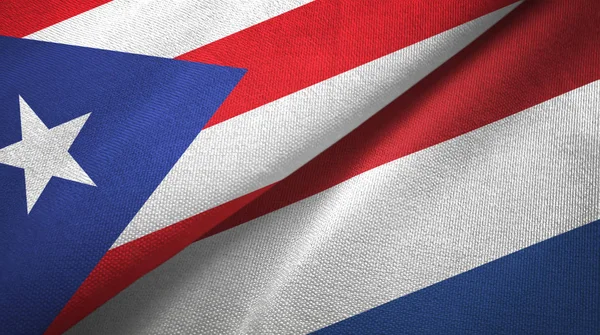 Puerto Rico en Nederland twee vlaggen textiel doek, stof textuur — Stockfoto
