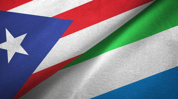 Puerto Rico en Sierra Leone twee vlaggen textiel doek, stof textuur — Stockfoto