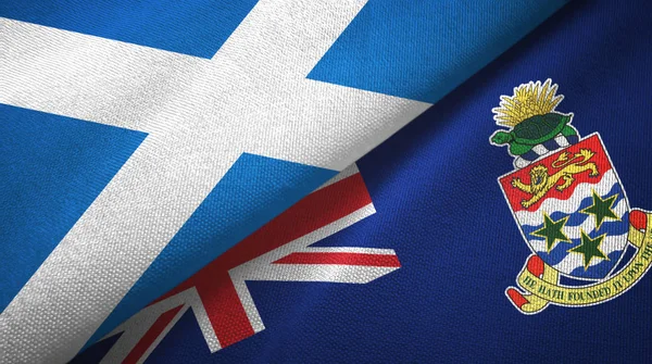 Шотландия и Каймановы острова два флага текстильная ткань, текстура ткани — стоковое фото