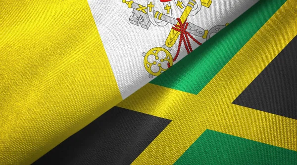 Watykan i Jamajka dwie flagi tkaniny tekstylne, tekstura tkaniny — Zdjęcie stockowe