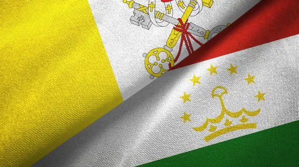 Watykan i Tadżykistan dwie flagi tkaniny tekstylne, tekstura tkaniny — Zdjęcie stockowe