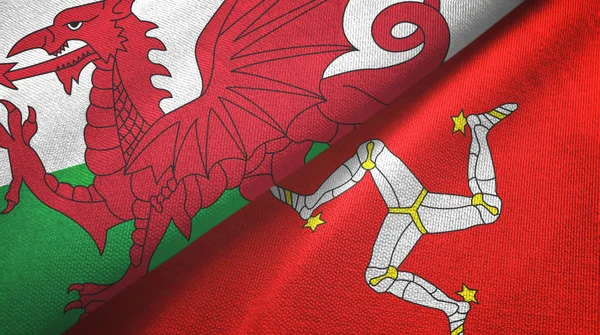 País de Gales e Ilha de Mann duas bandeiras de pano têxtil, textura de tecido — Fotografia de Stock
