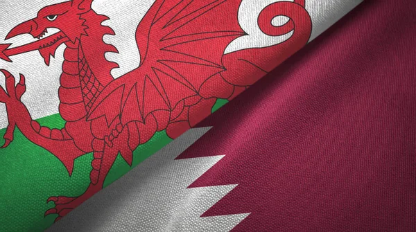 País de Gales e Qatar duas bandeiras de pano têxtil, textura de tecido — Fotografia de Stock